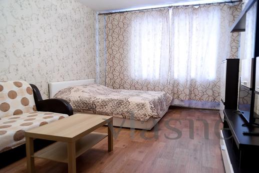 The apartment is located in the center of the city in an eli